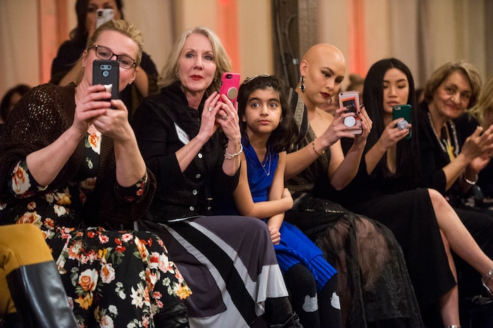 (Rick Egan  |  The Salt Lake Tribune)   Guests watch teh models come down the runway, at the 8th Annual Women of the World Fashion Show. The fashion show fund is raiser for the non-profit that seeks to help refugees settle in a new culture. Wednesday, March 7, 2018.