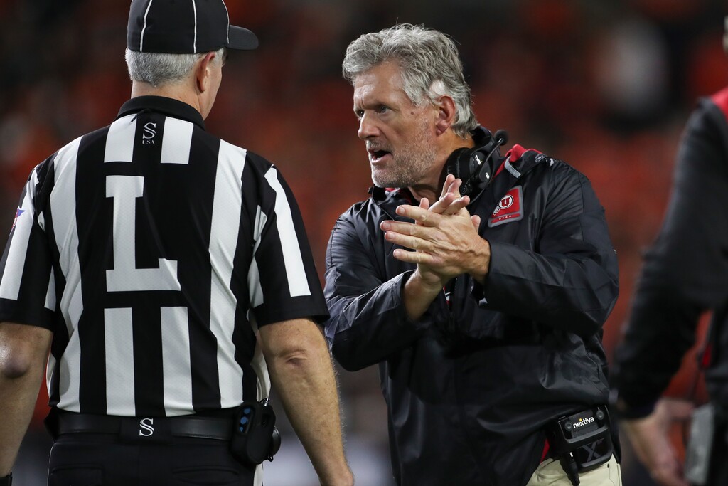 (Amanda Loman | AP) Utah head coach Kyle Whittingham talks with an official during an NCAA college football game against Oregon State Friday, Sept. 29, 2023, in Corvallis, Ore.