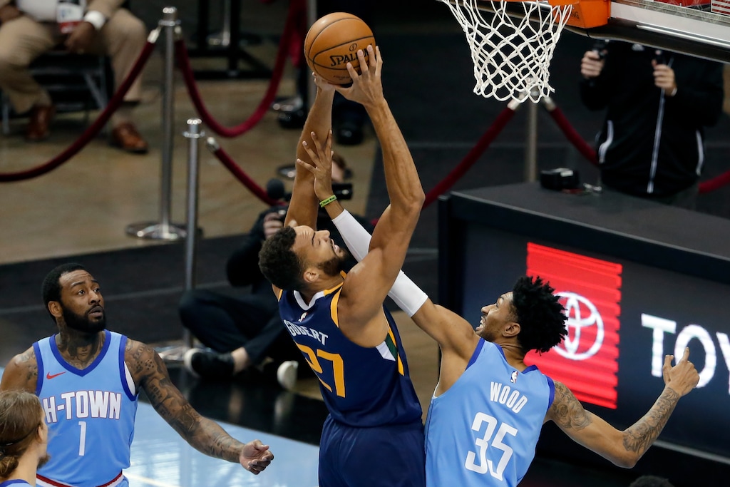 Utah Jazz center Rudy Gobert (27) puts up a shot as Houston Rockets center Christian Wood (35) reaches in while John Wall (1) looks on during the first half of an NBA basketball game Wednesday, April 21, 2021, in Houston. (AP Photo/Michael Wyke, Pool)