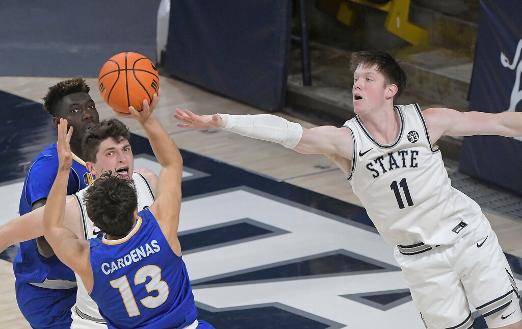 (Eli Lucero | The Herald Journal via AP) San Jose State guard Alvaro Cardenas (13) shoots as Utah State guard Max Shulga (11) defends during the first half of an NCAA college basketball game Saturday, Jan. 21, 2023, in Logan, Utah.