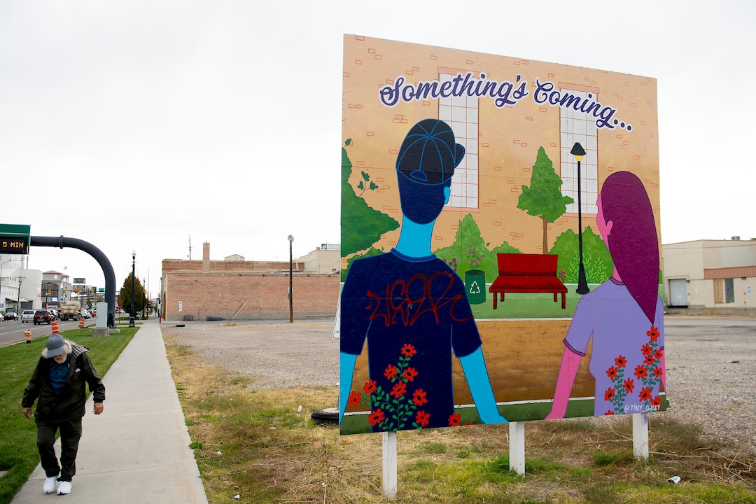 (Jeremy Harmon  |  The Salt Lake Tribune) A man walks past a sign on 500 South teasing a 12.4-acre area just west of downtown Salt Lake City. The development, called Post District, is mostly comprised of the block between 300 and 400 West and 500 and 600 South. Photographed on Thursday, Oct. 17, 2019.