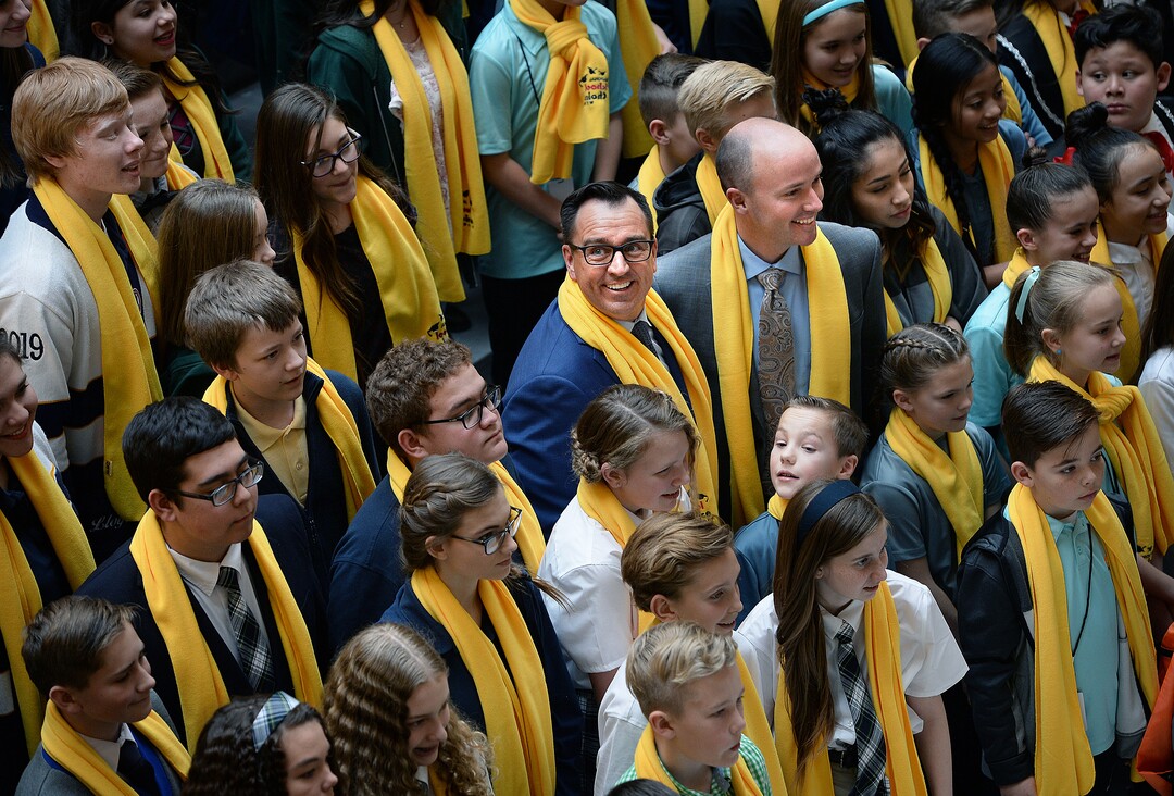 (Scott Sommerdorf   |  The Salt Lake Tribune)   Speaker of the House Greg Hughes, R-Draper, and Lt. Governor Spencer Cox, center, pose for a photo with charter school children during an event in the Capitol rotunda, Thursday, January 25, 2018.