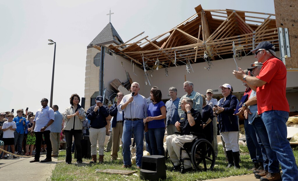 FILE - in this Aug. 31, 2017 file photo, Vice President Mike Pence, with his wife Karen, speaks to residents affected by Hurricane Harvey during a visit to the First Baptist Rockport Church in Rockport, Texas. The Federal Emergency Management Agency is rethinking a policy that routinely denies aid to religious institutions if the money will be used to rebuild sanctuaries damaged or destroyed in natural disasters. Several churches hit by recent hurricanes are challenging the policy in court. First Baptist's Senior Pastor Scott Jones said he doesn't fault others who seek FEMA aid, but his church won't be doing so. (AP Photo/Eric Gay, File)