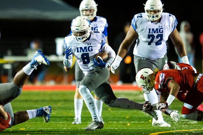 (Chris Detrick  |  The Salt Lake Tribune)  IMG Academy's Trey Sanders (6) runs for a touchdown past East's Viliami Tausinga (7) during the game at East High School Friday, October 20, 2017. 