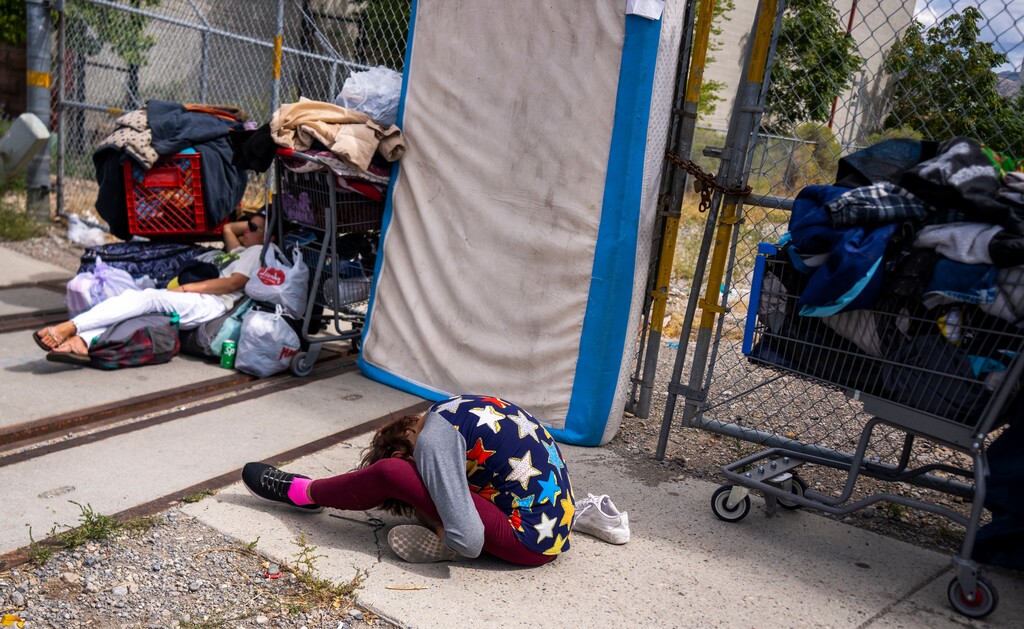 (Rick Egan | The Salt Lake Tribune)   People rest with all of their belongings, on the sidewalk, after being displaced from the park, when fences were erected on the public island on 500 West near 350 South Tuesday, Sept. 19, 2023.