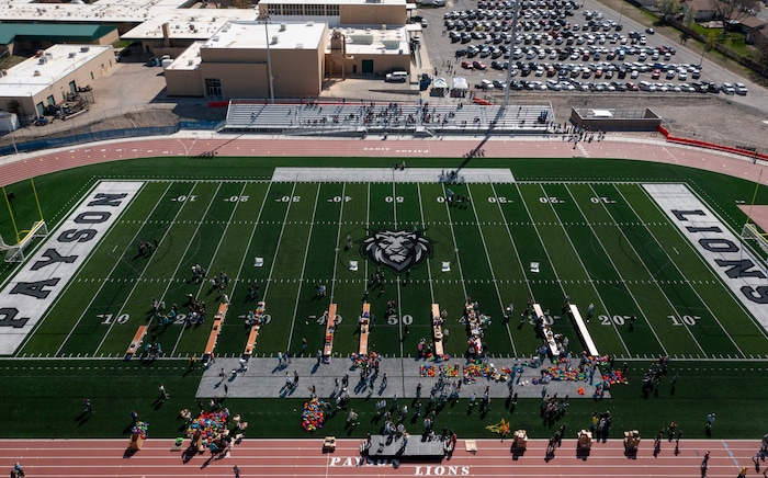 (Bethany Baker | The Salt Lake Tribune) Students and volunteers pack resource kits for Kevin Bacon’s nonprofit SixDegrees at a charity event to commemorate the 40th anniversary of the movie “Footloose” on the football field of Payson High School in Payson on Saturday, April 20, 2024.