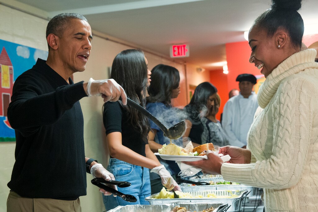 President Barack Obama serves Thanksgiving dinner during "Feast with Friends" at Friendship Place homeless center, on Wednesday, Nov. 25, 2015, in Washington. Friendship Place works with homeless and at-risk veterans in its Veterans First program. (AP Photo/Evan Vucci)