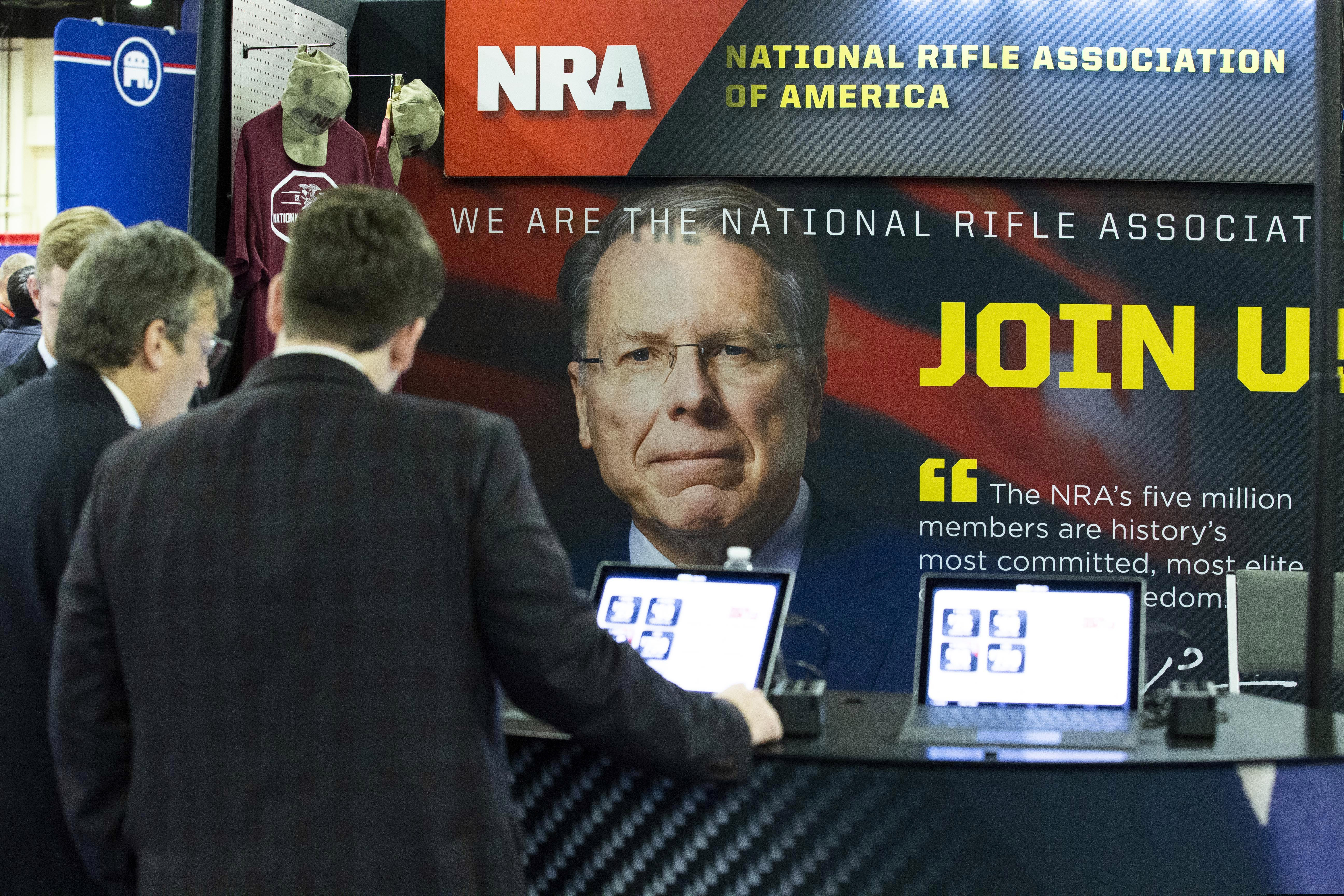 People at the NRA booth during Conservative Political Action Conference, CPAC 2020, at the National Harbor, in Oxon Hill, Md., Thursday, Feb. 27, 2020. (AP Photo/Jose Luis Magana)
