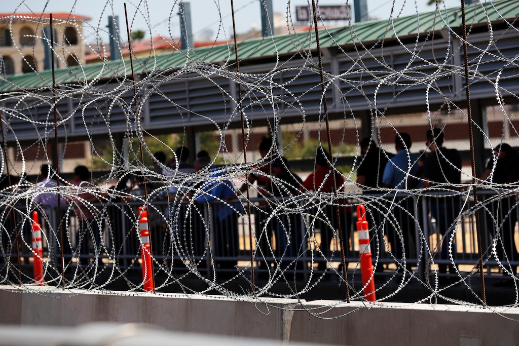 (Marco Ugarte | AP file photos) People line up to cross the border into the United States on International Bridge 1, in Nuevo Laredo, Mexico, on July 16, 2019.