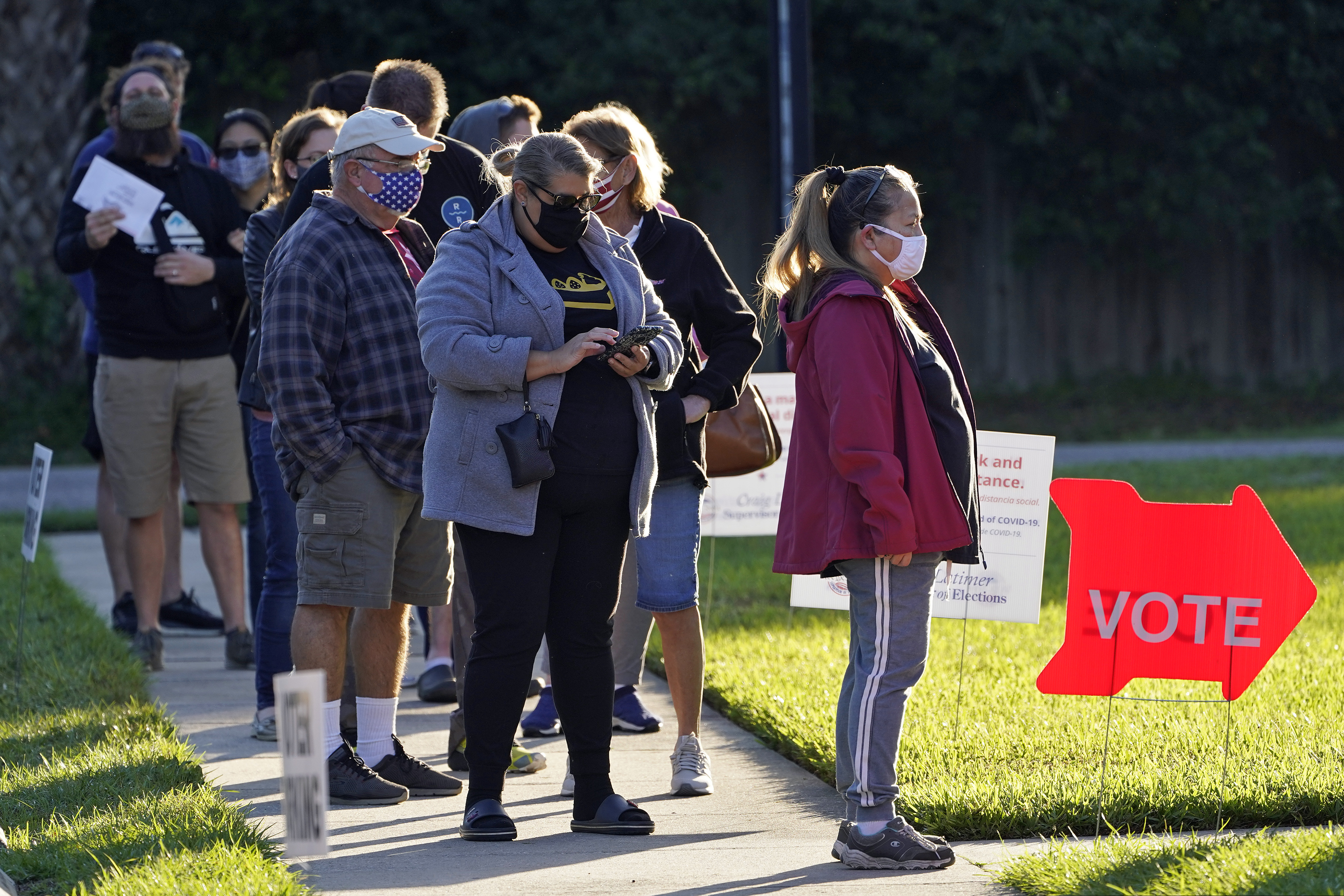 People wear protective face masks as they wait in line to vote at the Bell Shoals Baptist Church on election day Tuesday, Nov. 3, 2020, in Brandon, Fla. (AP Photo/Chris O'Meara)
