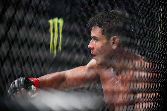 (Francisco Kjolseth | The Salt Lake Tribune) No. 6 ranked middleweight Paulo Costa of Brazil leans against the fence before continuing his fight against Luke Rockhold of the United States during their UFC 278 mixed martial arts bout in the octagon at Vivint Arena in Salt Lake City on Saturday, Aug. 20, 2022. 