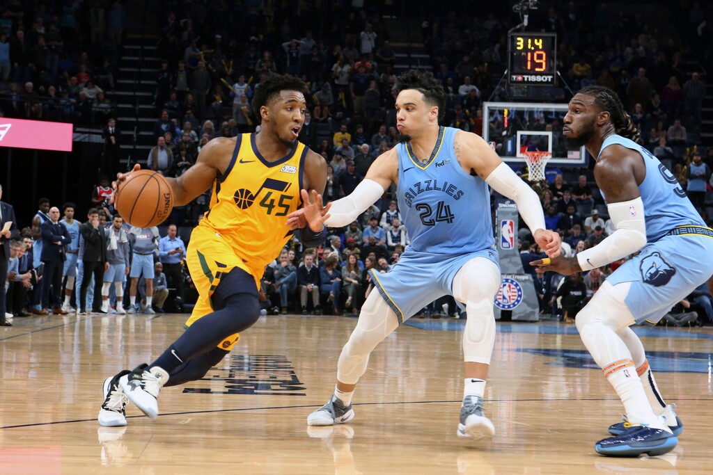 Utah Jazz Donovan Mitchell (45) drives the ball past Memphis Grizzlies' Dillon Brooks (24) during the second half of an NBA basketball game Friday, Nov. 15, 2019, in Memphis, Tenn. (AP Photo/Karen Pulfer Focht)
