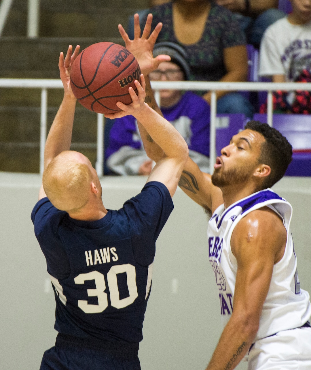 (Rick Egan  |  The Salt Lake Tribune)       Brigham Young Cougars guard TJ Haws (30) shoots as Weber State Wildcats forward Brekkott Chapman (23) defends, in basketball action between Brigham Young Cougars and Weber State Wildcats, at the Dee Event Center in Ogden, Saturday, Dec. 1, 2018.