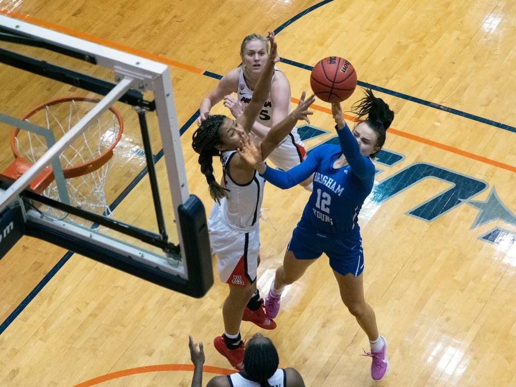 (Michael Thomas | AP) BYU forward Lauren Gustin (12) shoots over Arizona forward Sam Thomas, left, during the first half of a college basketball game in the second round of the NCAA women's tournament at the UTSA Convocation Center in San Antonio, Wednesday, March 24, 2021.