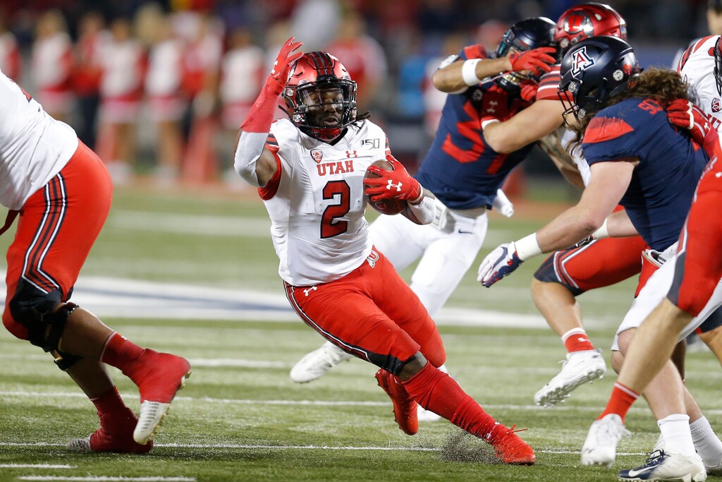 (Rick Scuteri | AP file photo) Utah running back Zack Moss (2) runs for a first down against Arizona during the first half of an NCAA college football game Saturday, Nov. 23, 2019, in Tucson, Ariz.