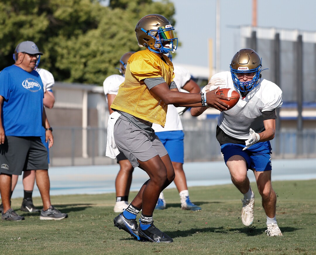 (Gary Kazanjian | Special to The Tribune) Clovis High School quarterback Nate Johnson works out with his team at Clovis High School, who committed to play for the University of Utah, shown Wednesday, July 28, 2021, in Clovis, Calif.