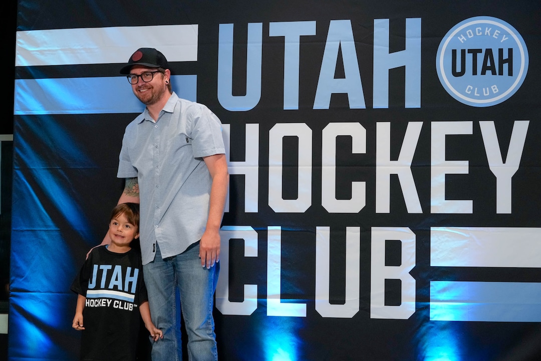 (Francisco Kjolseth  |  The Salt Lake Tribune) Garrett Stone and his son Levi, 4, pose for a picture as they attend the NHL draft party at the Delta Center in Salt Lake City on Friday, June 28, 2024.