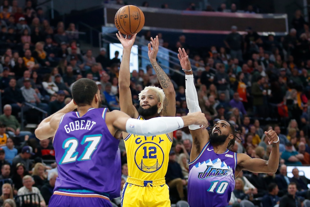 Golden State Warriors guard Ky Bowman (12) shoots as Utah Jazz's Rudy Gobert (27) and Mike Conley (10) defend in the first half during an NBA basketball game Friday, Nov. 22, 2019, in Salt Lake City. (AP Photo/Rick Bowmer)