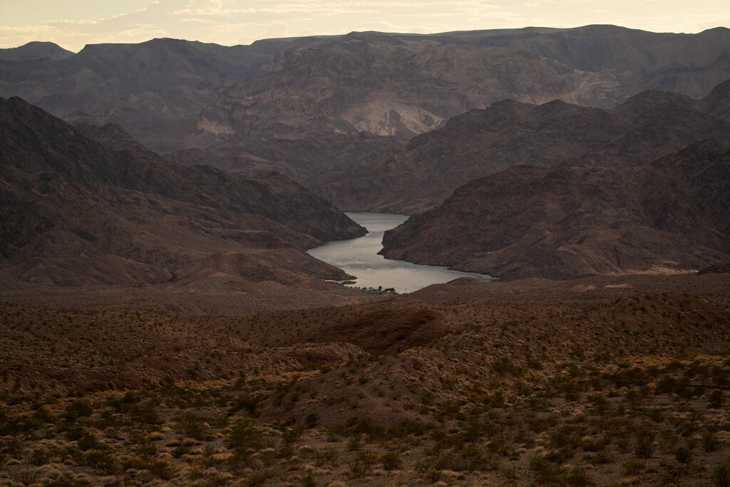 (John Locher | AP file photo) Water flows down the Colorado River downriver from Hoover Dam in northwest Arizona, on Aug. 14, 2022, near the Lake Mead National Recreation Area. The Biden administration on Tuesday, April 11, 2023, released an environmental analysis of competing plans for how Western states and tribes reliant on the dwindling Colorado River should cut their use.