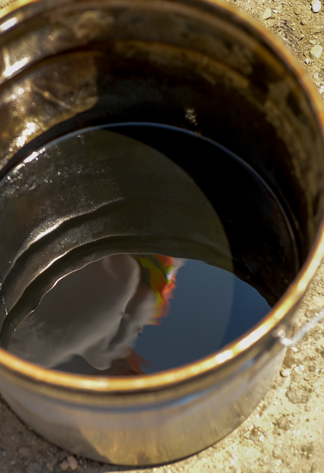 Leah Hogsten  |  The Salt Lake Tribune    A bucket of extracted crude oil from Petrotech Energy's Asphalt Ridge quarry, Thursday, June 14, 2018. Petrotech claims to have perfected a process to extract commercial quantities of crude from the Unita BasinÕs vast tar sands in a cost-effective, yet environmentally friendly manner using a proprietary cocktail of solvents. 