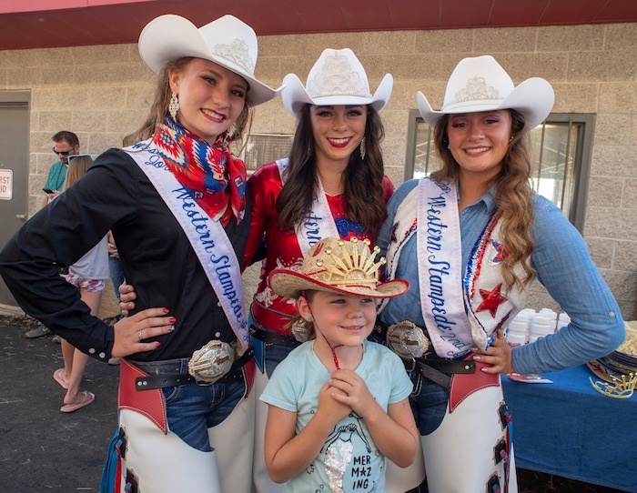(Rick Egan  |  The Salt Lake Tribune)    Brinley Bingham form Provo celebrates her 7th birthday posing for a photo with the Rodeo royalty, Madelyn Mundy, 2nd attendant, Reagann McCurdy Queen, and Ashlyn Montague first attendant, at the West Jordan Western Stampede Rodeo, Saturday, July 6, 2019.