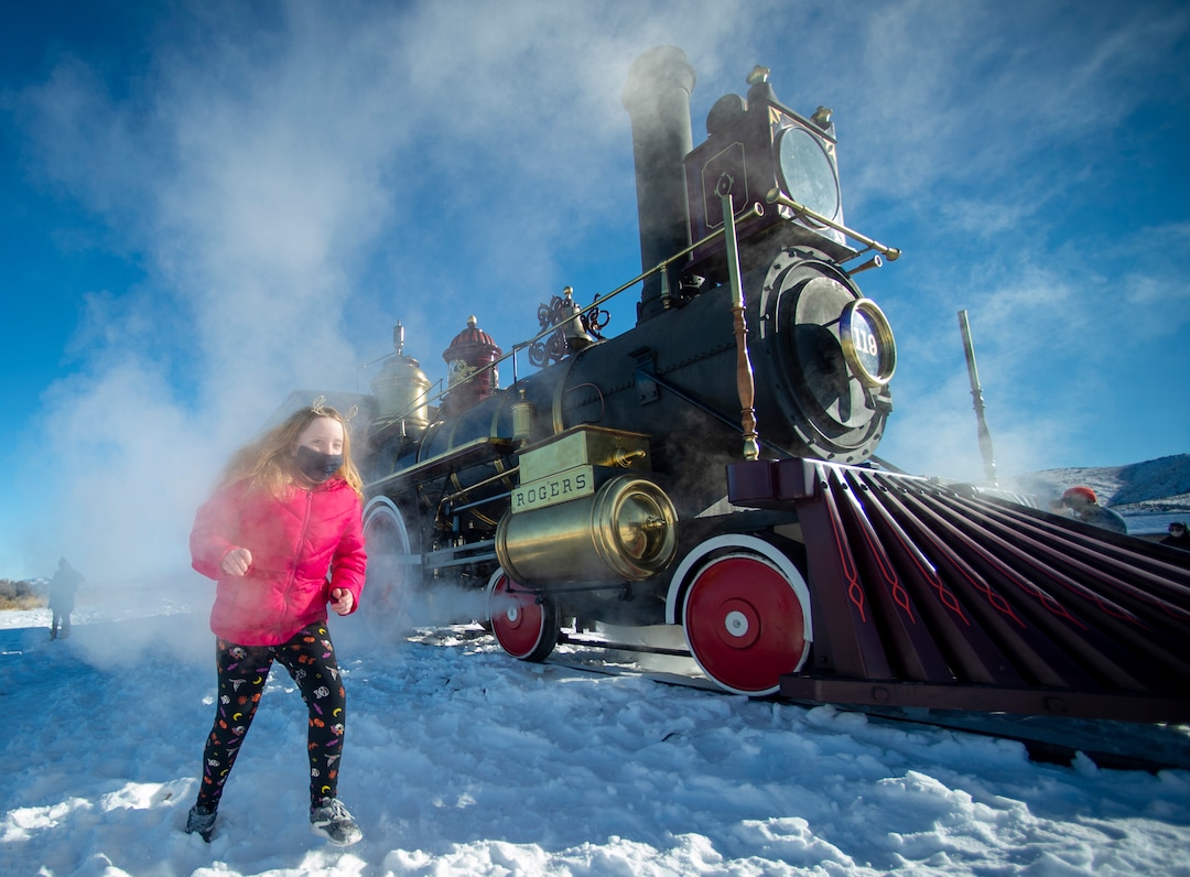 (Rick Egan | The Salt Lake Tribune) McKenzie Kennedy, 10, runs through the steam coming from Steam Engine 119 at the Golden Spike National Historical Park during one of the winter steam locomotive demonstrations, on Tuesday, Dec. 29, 2020.