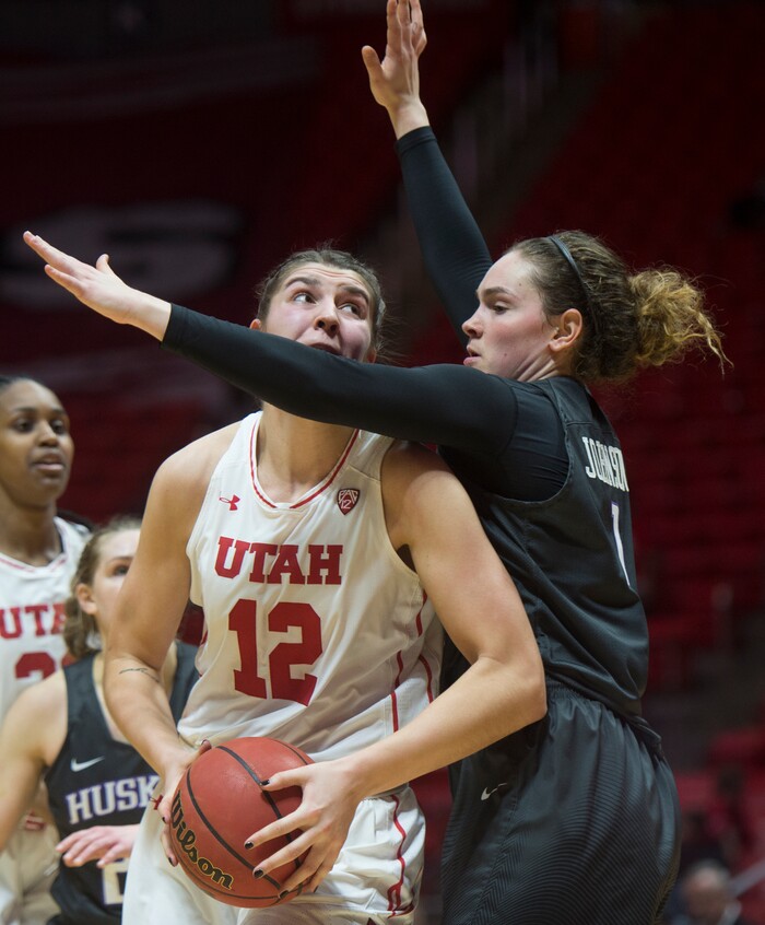 (Rick Egan  |  The Salt Lake Tribune)      Utah Utes forward Emily Potter (12) tries to get past Washington Huskies forward Hannah Johnson (1), in PAC-12 women's basketball action at the Jon M. Huntsman Center, Sunday, Feb. 18, 2018.