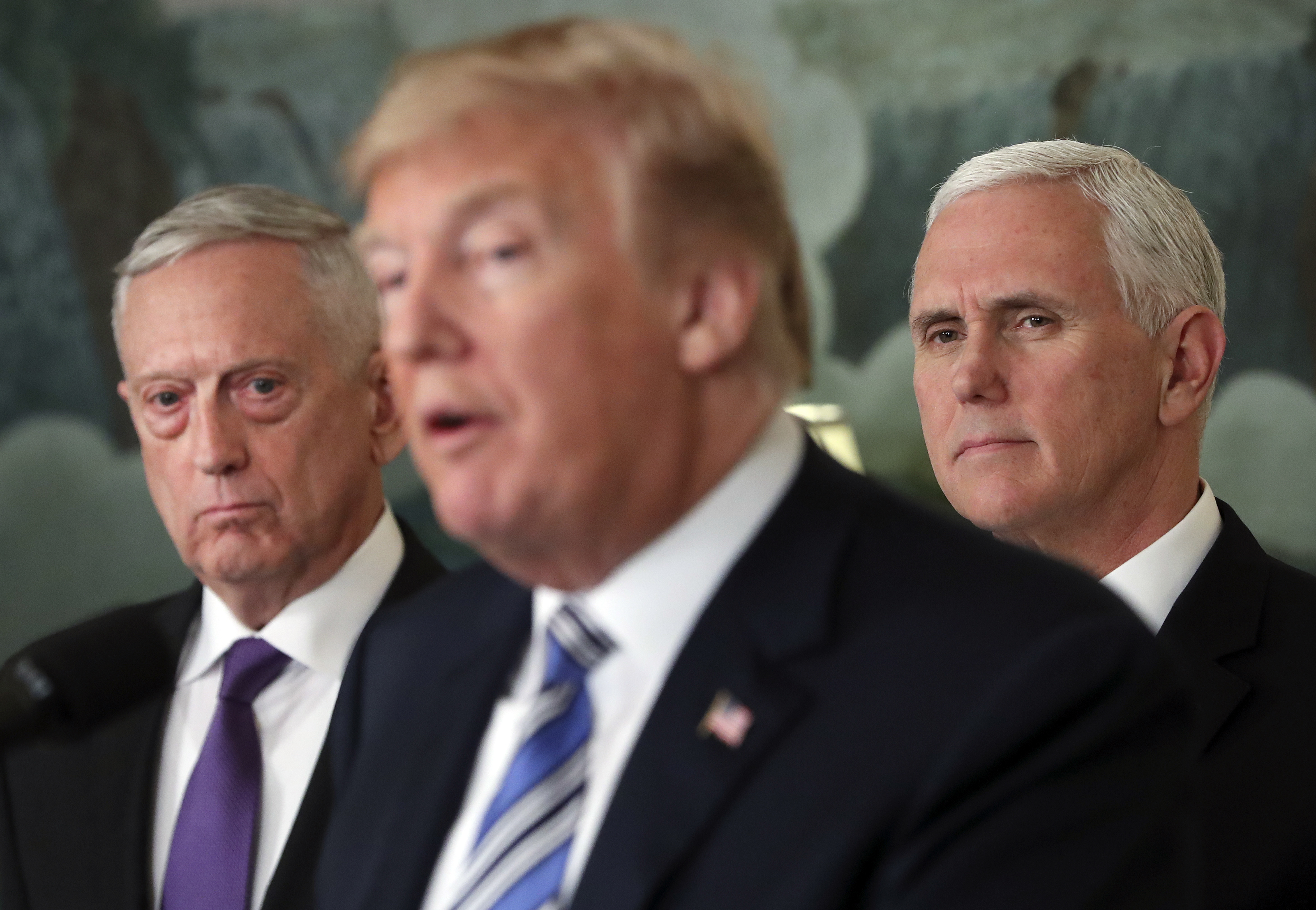 FILE - In this March 23, 2018 file photo, Defense Secretary Jim Mattis, left, and Vice President Mike Pence, right, listen to President Donald Trump, center, speaks in the Diplomatic Room of the White House in Washington. Mattis warns bitter political divisions have pushed American society to the “breaking point” in his most extensive public remarks since he resigned in protest from the Trump administration. (AP Photo/Pablo Martinez Monsivais)