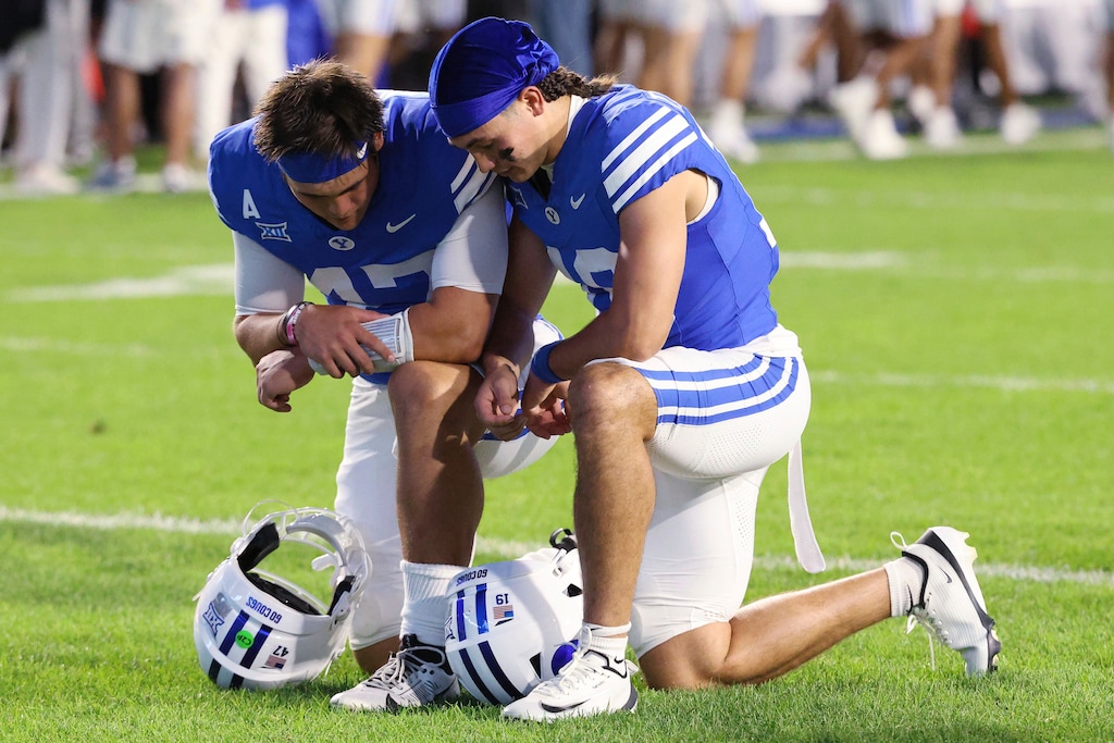 (Jeffrey D. Allred | AP) BYU quarterback Bear Bachmeier, left, and his brother BYU wide receiver Tiger Bachmeier pray prior to an NCAA college football game Saturday, Sept. 6, 2025, in Provo.