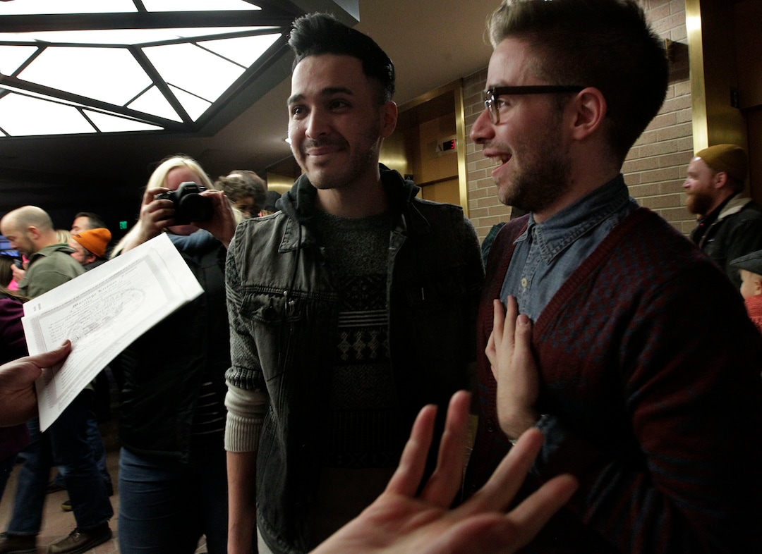 Leah Hogsten  |  The Salt Lake Tribunel-r Jeffery Gomez and James Goodman  react after being told that they are officially married in the lobby of the Salt Lake County offices, Friday December 20, 2013. Several hundred people descended on the Salt Lake County ClerkÕs Office Friday afternoon to get licenses. U.S. District Court Judge Robert J. Shelby in Utah Friday struck down the stateÕs ban on same-sex marriage, saying the law violates the U.S. ConstitutionÕs guarantees of equal protection and due process.
