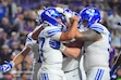 (LM Otero | AP Photo) BYU quarterback Bear Bachmeier, front left, is congratulated by teammates after running for a touchdown during the first half of an NCAA college football game against TCU, Saturday, Oct. 3, 2026, in Fort Worth, Texas.