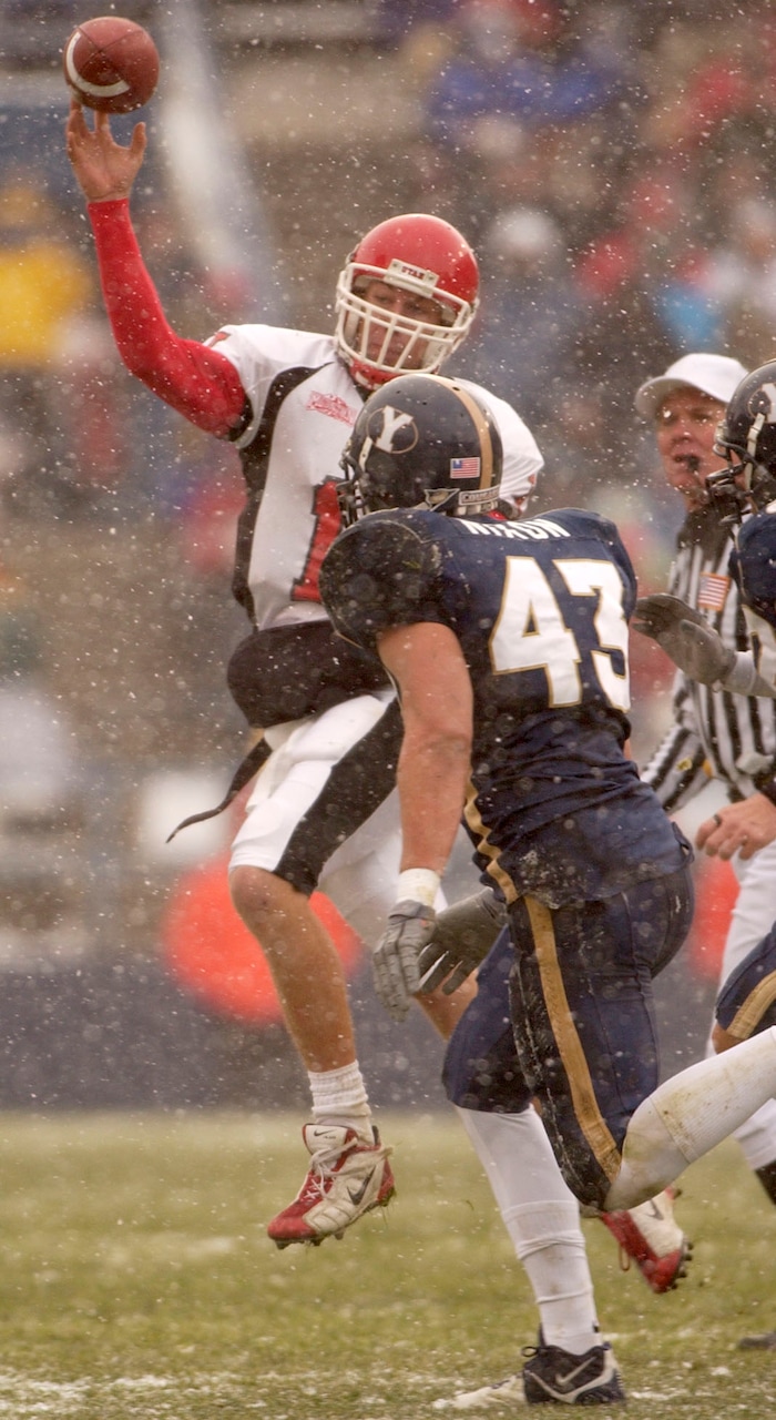 (Trent Nelson  |  Tribune file photo)  Utah quarterback Alex Smith throws under pressure from BYU's David Nixon on Saturday November 22, 2003 at LaVell Edwards Stadium.