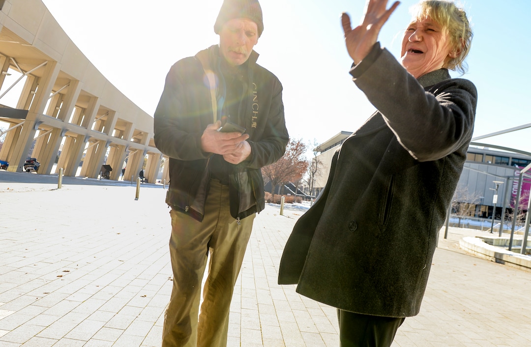 (Leah Hogsten  |  The Salt Lake Tribune)  Katherine Barrett, 54, greets an aquaintance outside the Salt Lake Library. "We're starting to have hope again," said Katherine Barrett, 54, of finding housing for her and her husband Ron Barrett, 55, center, who have been living on the streets of Salt Lake City for the past two years. The Barretts are trying to find housing through a Shelter Plus Care housing voucher through the Salt Lake City Housing Authority. The couple says they refuse to stay in the state's largest homeless shelter, The Road Home on Rio Grande Street, because of past threats of violence from other residents.
