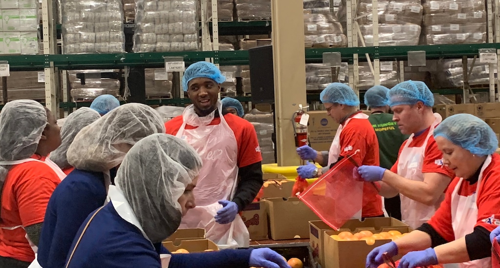 (Eric Walden  |  The Salt Lake Tribune) Utah Jazz guard Donovan Mitchell shares a laugh with some volunteers at the NBA Cares Day of Service while boxing up produce at the Greater Chicago Food Depository on Friday, Feb. 14, 2020.