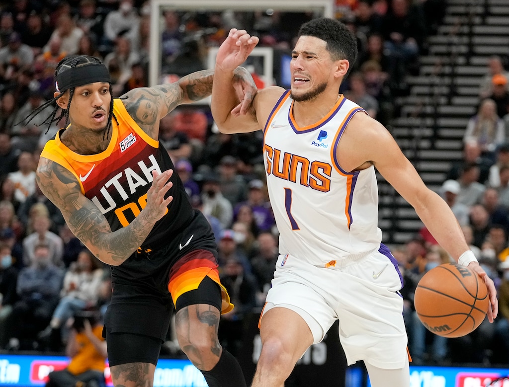 (Leah Hogsten | The Salt Lake Tribune) Utah Jazz guard Jordan Clarkson (00) fouls Phoenix Suns guard Devin Booker (1) as the Utah Jazz host the Phoenix Suns at Vivint Arena, Jan. 26, 2022. 
