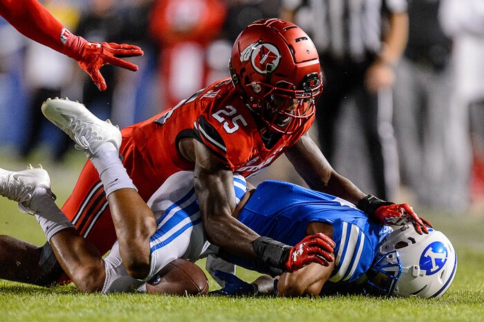 (Trent Nelson | The Salt Lake Tribune)  Utah Utes defensive back Casey Hughes (25) pushes Brigham Young Cougars running back Trey Dye (4) into the ground as BYU hosts Utah, NCAA football in Provo, Saturday September 9, 2017.