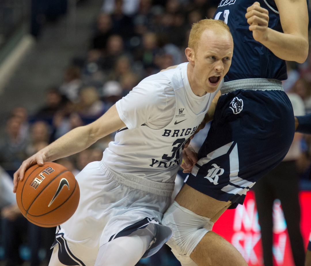 (Rick Egan  |  The Salt Lake Tribune)   Brigham Young Cougars guard TJ Haws (30) takes the ball down the middle, as Rice Owls forward Quentin Millora-Brown (42) defends, in basketball action between Brigham Young Cougars and Rice Owls, at the Marriott Center in Provo, Wednesday, Nov. 21, 2018.
