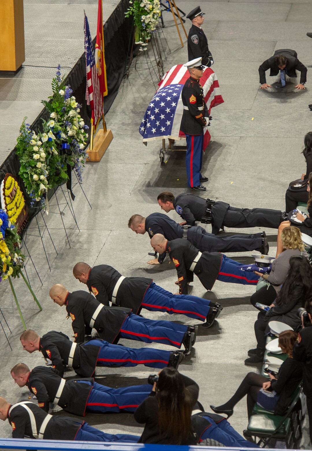 (Rick Egan  |  The Salt Lake Tribune)     Members of the United States Marine Corps do push-ups, during the funeral for South Salt Lake police officer David Romrell, at the Maverik Center in West Valley City, Wednesday, Dec. 5, 2018.