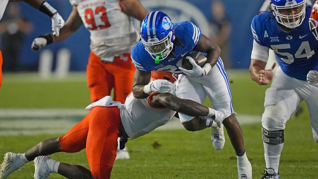 (Rick Bowmer | AP) BYU running back Deion Smith (20) carries the ball against Sam Houston State during the first half of an NCAA college football game Saturday, Sept. 2, 2023, in Provo.