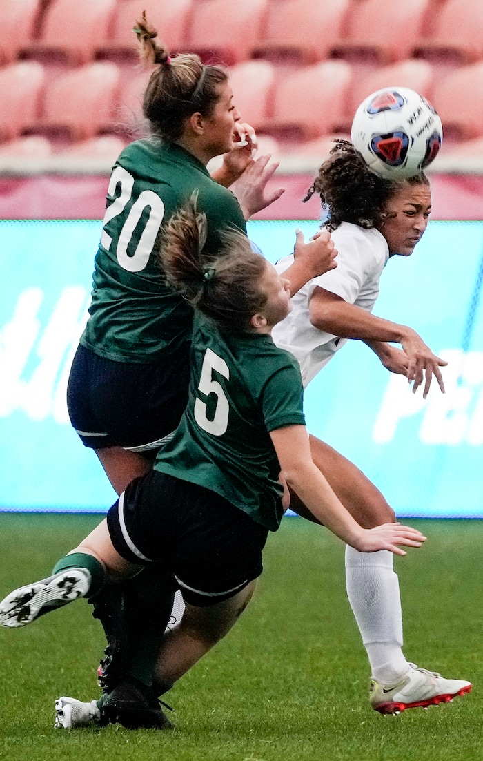 (Leah Hogsten | The Salt Lake Tribune) RHSM's Zakarie Smith (20) and Beatrix Wall (5) battle Waterford's Seven Castain (7) for possession. Waterford School takes on Rowland Hall-St. Marks High School during their 2A State Soccer Championship game Oct. 23, 2021 at Rio Tinto Stadium.
