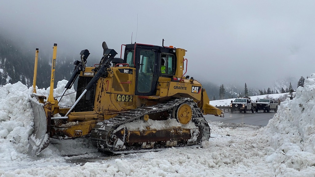 (Utah Department of Transportation) UDOT workers use a bulldozer to clear off State Route 210 through Little Cottonwood Canyon on April 13, 2023. The agency had to close the canyon completely for eight days in an 11-day stretch at the beginning of April 2023 because of high avalanche danger.