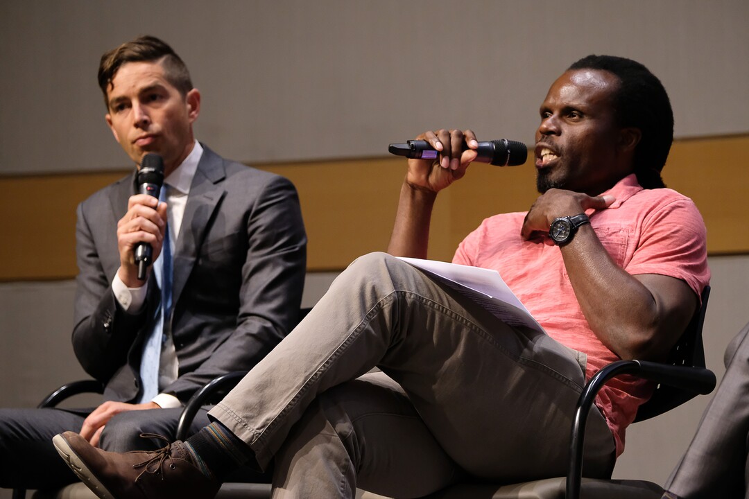(Francisco Kjolseth  |  The Salt Lake Tribune)  Ali Olufeko sitting in for Rainer Huck makes a point about police brutality alongside David Garbett during a debate for Salt Lake City mayor at the Salt Lake City Library on Wed. June 26, 2019.