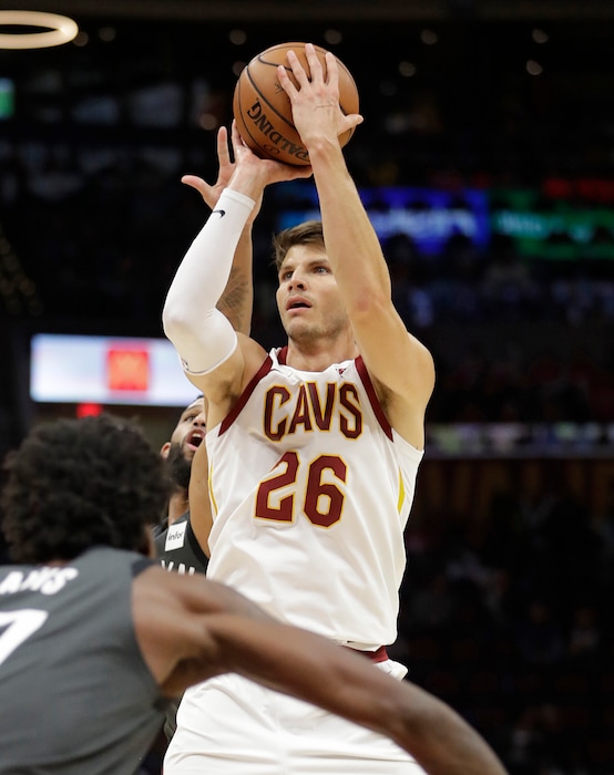FILE - In this Oct. 24, 2018, file photo, Cleveland Cavaliers' Kyle Korver (26) shoots over Brooklyn Nets' Ed Davis (17) in the second half of an NBA basketball game in Cleveland. The Cavaliers will rebuild without Kyle Korver. Cleveland finalized its trade with Utah on Thursday, Nov. 29, 2018, by trading Korver to the Jazz for guard Alec Burks and two future second-round draft picks. Korver had hoped to be sent to a contender and the Cavs granted his wish.(AP Photo/Tony Dejak, File)
