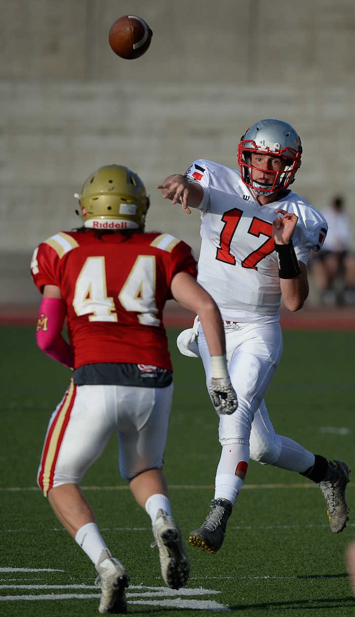 (Francisco Kjolseth  |  The Salt Lake Tribune)  Kyle King of Manti finds an open teammate as he passes over Johan Hester of Judge in the Class 3A football playoff game at Judge Memorial on Thursday, Oct. 19, 2017. 