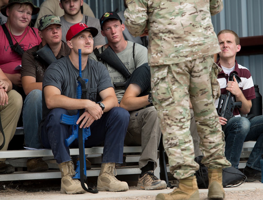 (Leah Hogsten  |  The Salt Lake Tribune) Attendees of the Utah National Guard Special Forces Survival Training Experience, August 10-12 at Camp Williams receive direction from Sgt. Major Gerhauser.