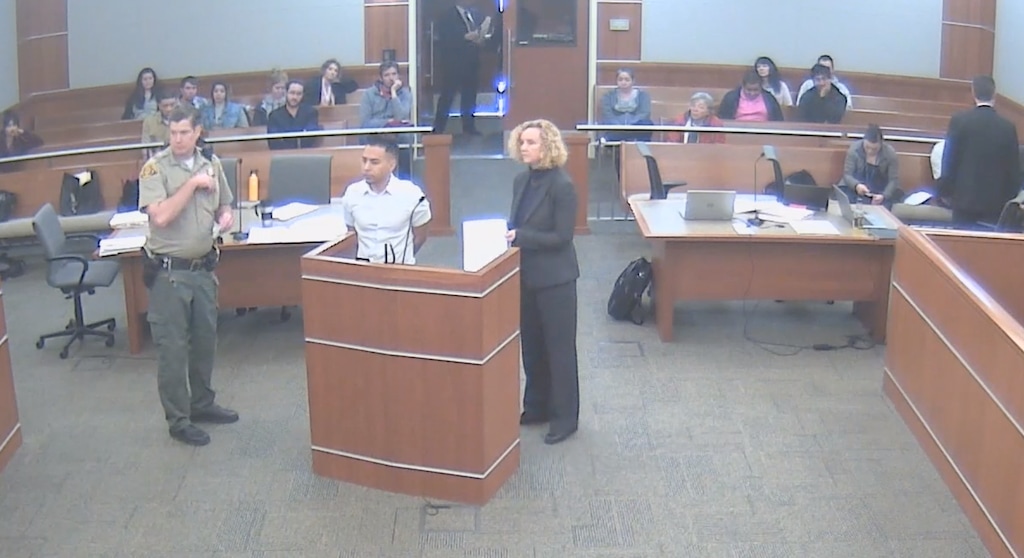 (Screenshot of 3rd District Court video) Luis Sanchez stands next to his attorney, Heather Chesnut, after he was arrested for being late to a 2018 court hearing. Sanchez has filed a lawsuit alleging that his public defenders schemed to get an arrest warrant and put him in jail because he wanted to fight the criminal charges against him.