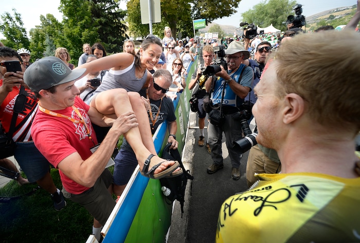(Scott Sommerdorf   |  The Salt Lake Tribune)   Robert Britton's girlfriend Ricki Hagen is lifted over the barrier from her spot in the crowd after Britton won the 2017 Tour of Utah, Sunday, August 6, 2017.