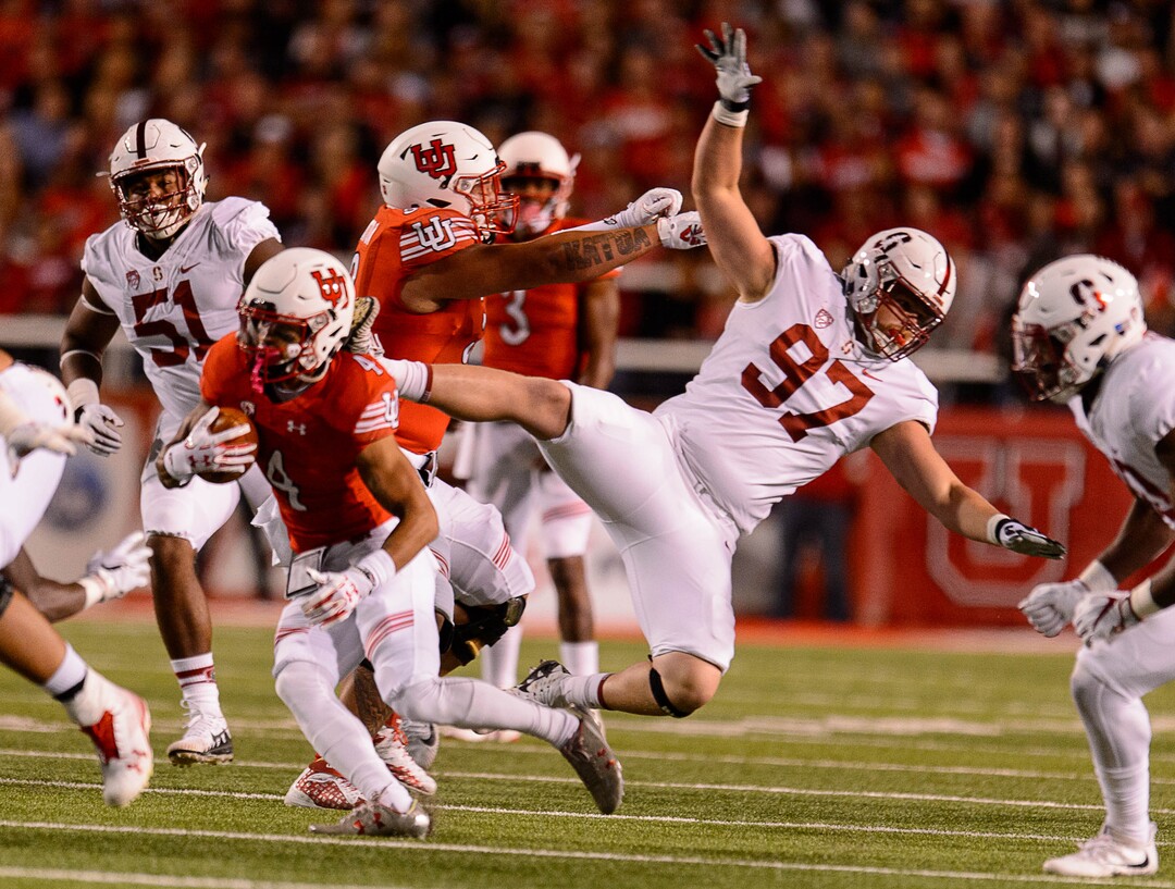 (Trent Nelson | The Salt Lake Tribune)  Utah Utes running back Troy McCormick Jr. (4) runs the ball as Stanford Cardinal defensive end Dylan Jackson (97) goes flying, when the University of Utah hosts Stanford, NCAA football at Rice-Eccles Stadium in Salt Lake City Saturday October 7, 2017.