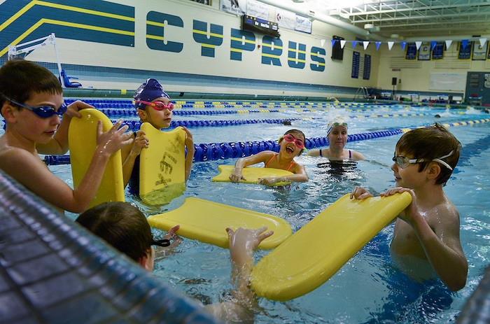 (Leah Hogsten | The Salt Lake Tribune) Members of the Pirate Swim Club, the oldest swim club in the state, perfect their craft during practice on a Tuesday evening under the tutelage of club coach Kelli Whipple, center. Cyprus High School has grown and changed since the gym and what may be the state's oldest operating indoor pool were constructed in 1955. A new school is in the works, badly needed to accommodate a growing population on the west side's close-knit community, where long-time fans show up no matter how good or bad the Pirates are.