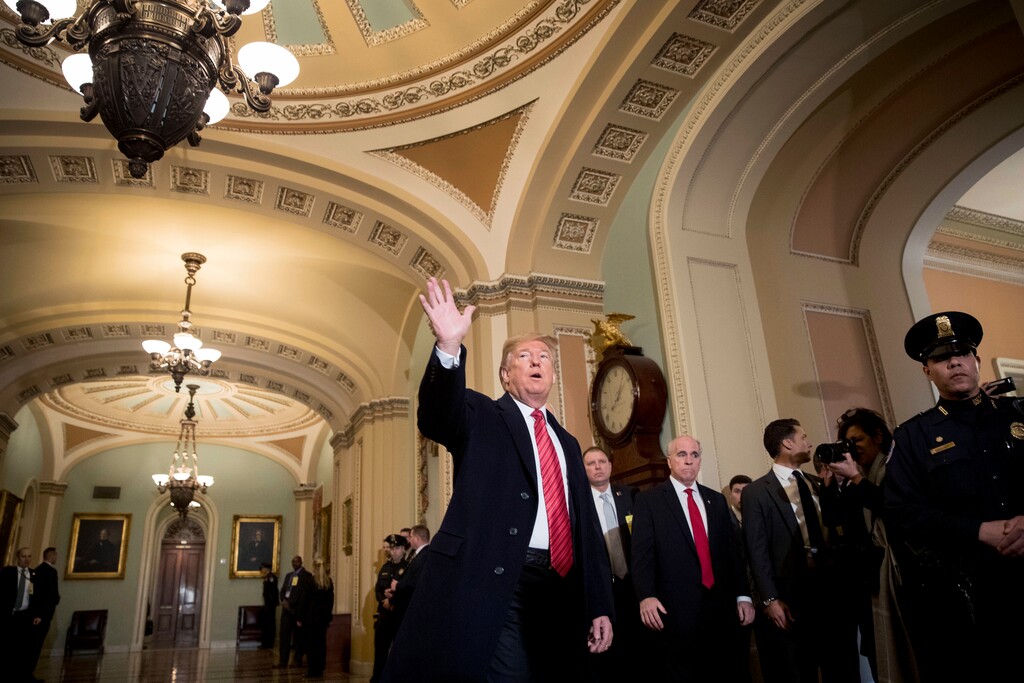 President Donald Trump, accompanied by Vice President Mike Pence, waves to members of the media as he arrives for a Senate Republican Policy lunch on Capitol Hill in Washington, Wednesday, Jan. 9, 2019. (AP Photo/Andrew Harnik)